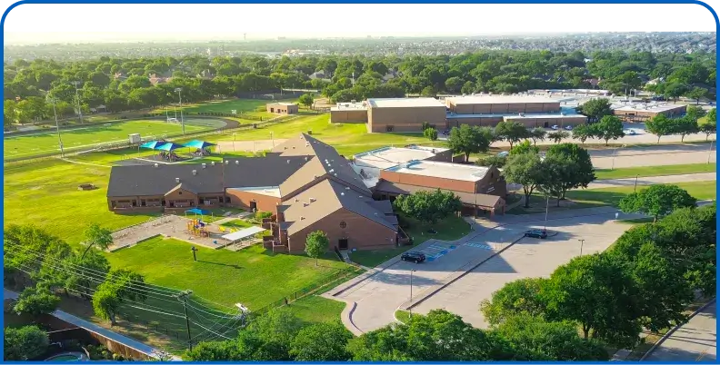 Aerial view of a K-12 school campus and athletic field