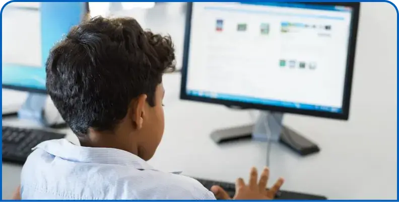 Student viewing a computer screen in a school computer lab
